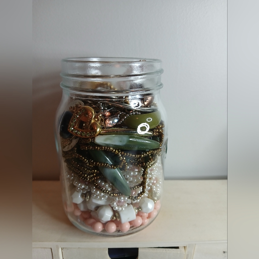 Assorted Beads and Charms in Glass Jar